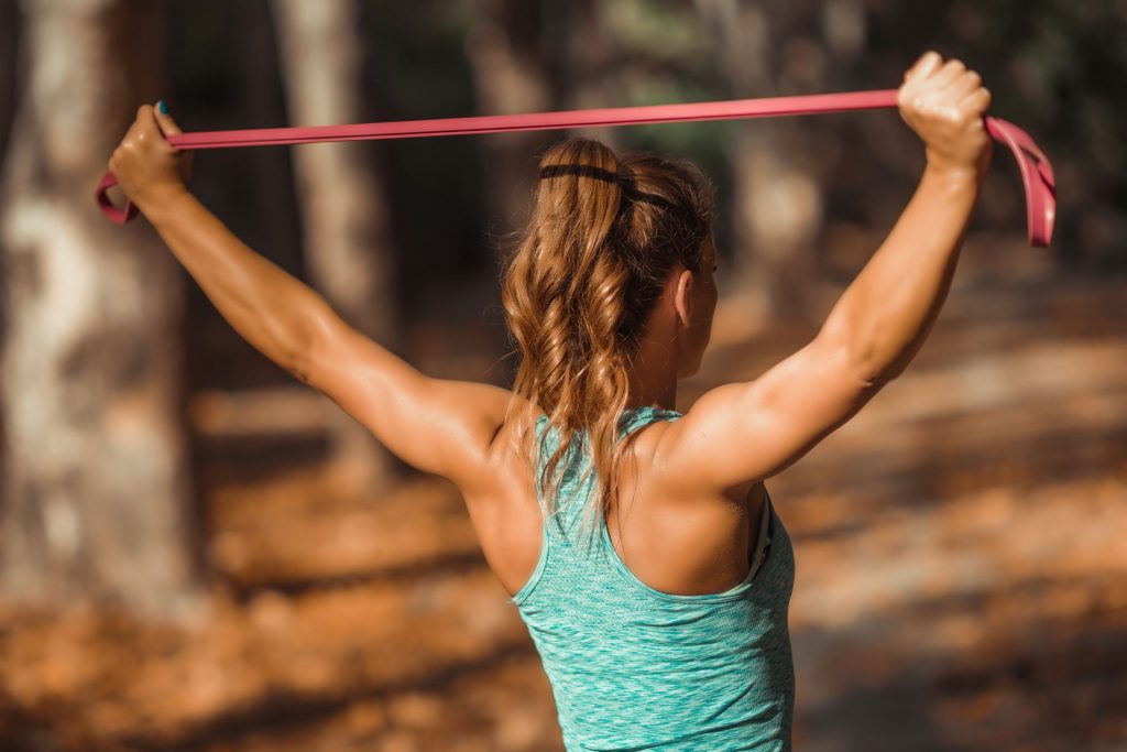 Woman using resistance bands to stretch